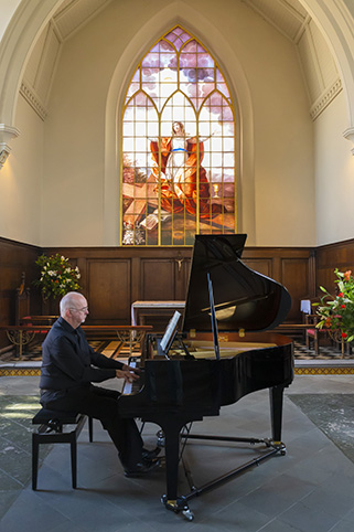Martin playing the baby grand piano in St Alkmund's Church, Shrewsbury