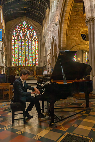 Max Walsh playing the Kawai grand piano in St Mary's Church
