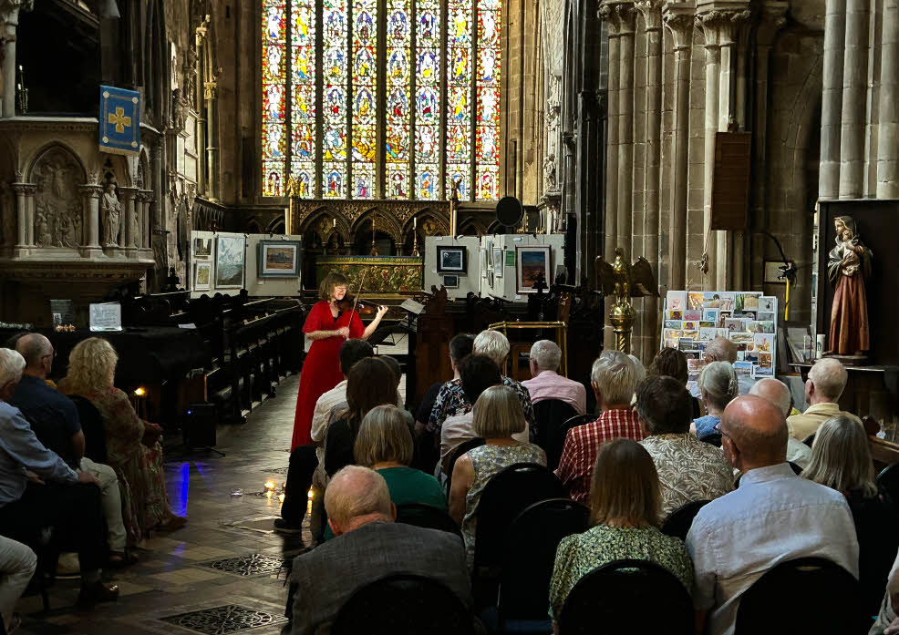 Fenella performing in front of the Jesse Window in St Mary's